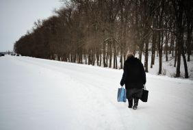 An old woman follows road