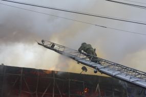 Пожарный поднимается по лестнице