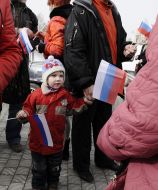Child stands with flag of Russia