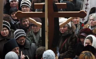 Participants of picket near a cross