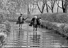 Men go on the flooded road