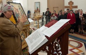 A parishioner conducts the mystery the sacrament of Anointing