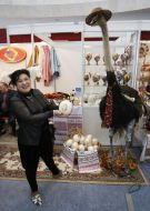 The participant of fair demonstrates painted easter egg