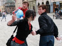 A young man pouring water girl