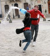 A young man pouring water girl