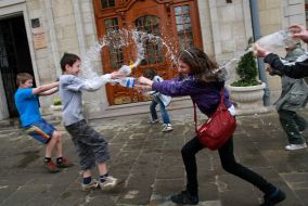 A young man pouring water girl