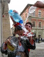 A young man pouring water girl