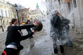 A young man pouring water girl