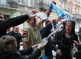 A young man pouring water girl