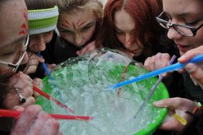 Young people inflate soap-bubbles