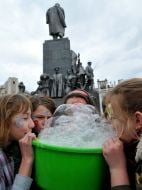 Young people inflate soap-bubbles