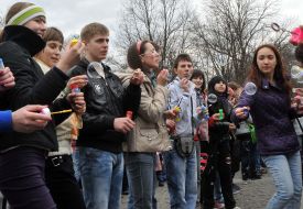 Young people inflate soap-bubbles