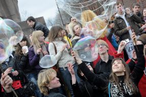 Young people inflate soap-bubbles
