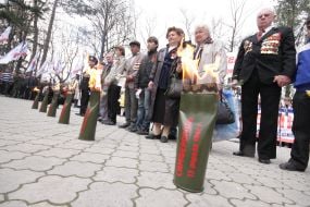 Veterans stand near burning front-line relay