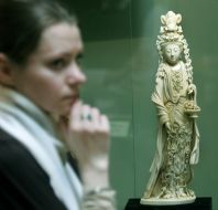 A girl considers the sculpture