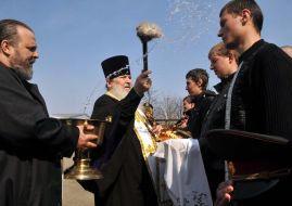 A priest blesses conscripts on military service