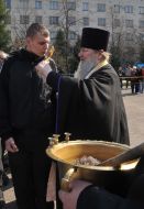 A priest blesses conscript on military service