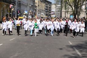 Young people in white dressing-gowns run