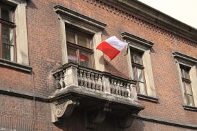 State flag of Poland tied with black ribbon