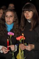 Girls hold alight candles