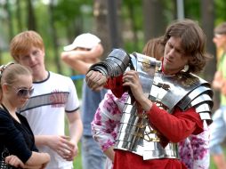 A young man puts on аrmour