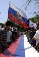 Young people carry the 30-meter flag of Russia