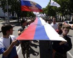 Young people carry the 30-meter flag of Russia