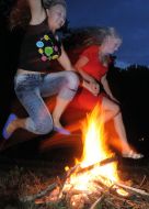 Girls jump through a fire