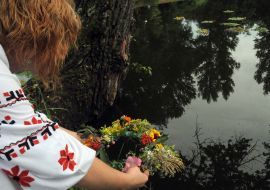A girl puts a chaplet into water