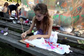 Girl covers with drawing a sport shirt