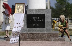 Girl wipes the pedestal of monument