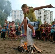 Girl jumps through a fire