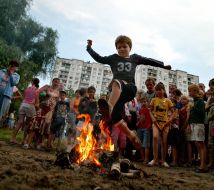 A boy jumps through a fire