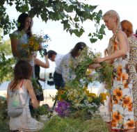 Girls braid chaplets from the fields flowers