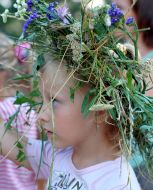 Girl in a chaplet from the fields flowers