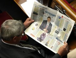 Deputy reads a newspaper