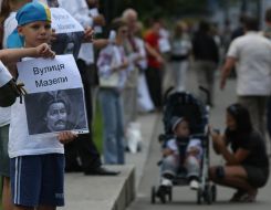 The boy holds a portrait of Ivan Mazepa