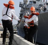 The sailors moored to the pier frigate ”Jean de Vienne”