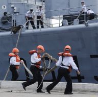 The sailors moored to the pier frigate ”Jean de Vienne”