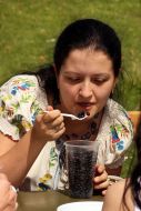 A girl eats a bilberry