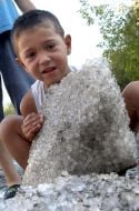 A boy plays with a hail