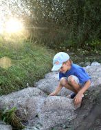 A boy plays with a hail