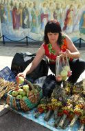 A woman lays apples in a basket