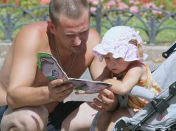A man reads a book a child