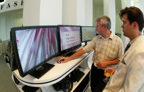 Visitors examine monitors