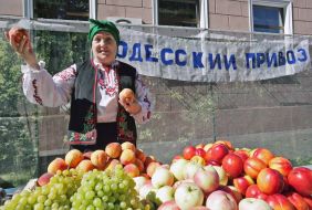 A woman sells fruits and berries