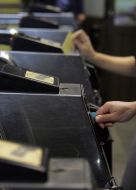 Passengers pass through a turnstile