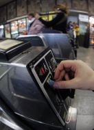 Passengers pass through a turnstile