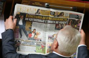 Deputy reads a newspaper