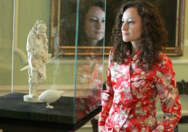 Visitor examines a statuette